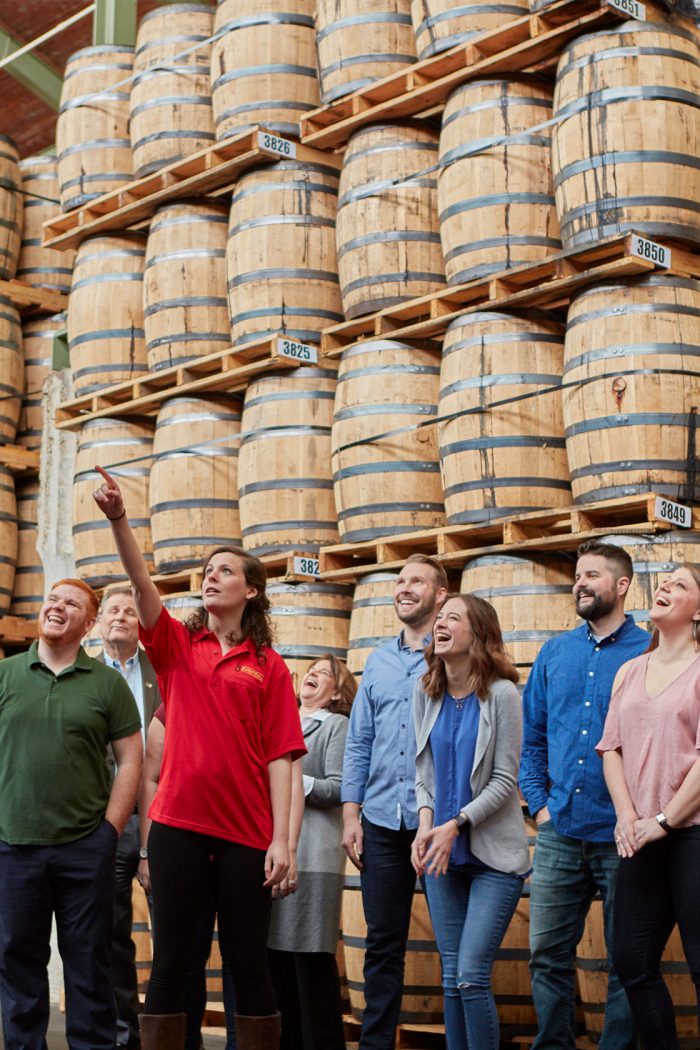 Tour group with tour guide pointing out a feature of the distillery