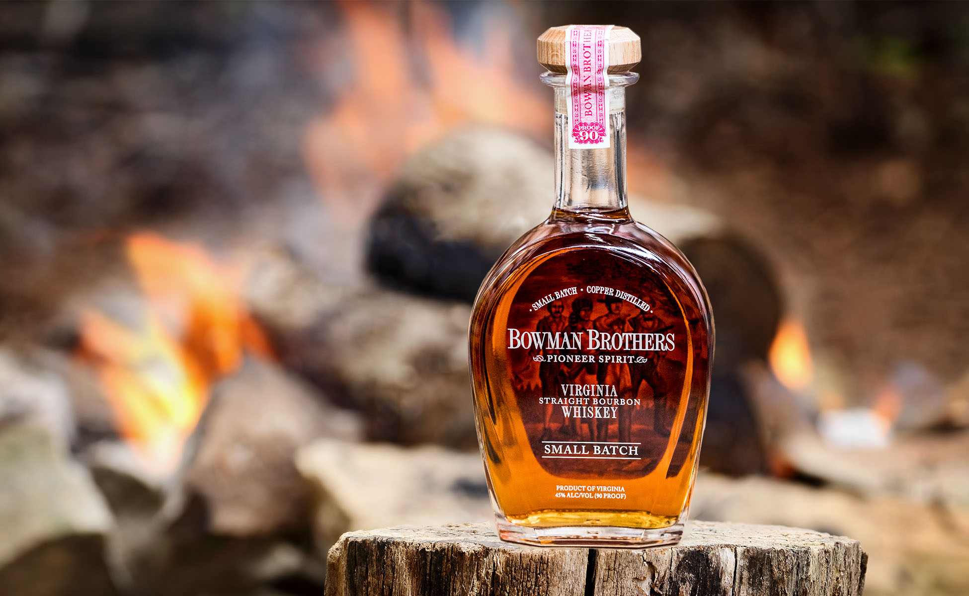 Bottle of Bowman Brothers by a campfire